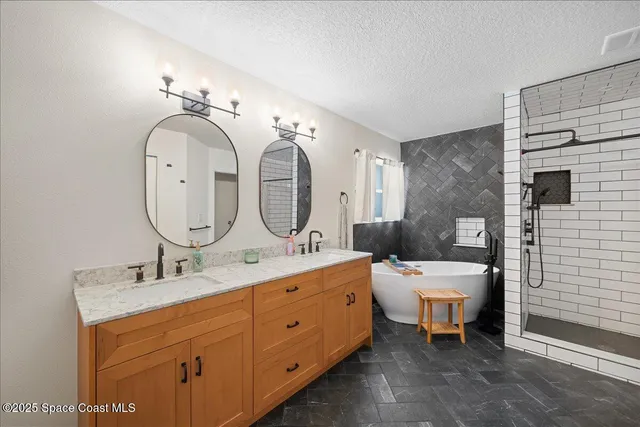 a bathroom with a bathtub and shower