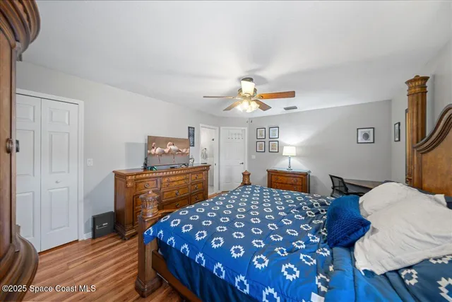 a bedroom with a bed and wooden floor