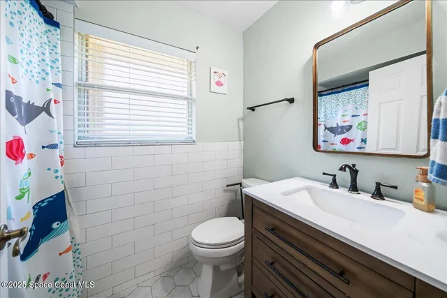 a bathroom with a bathtub and a shower curtain