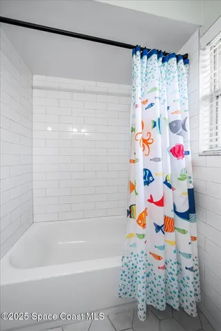 a living room with furniture a rug and a chandelier
