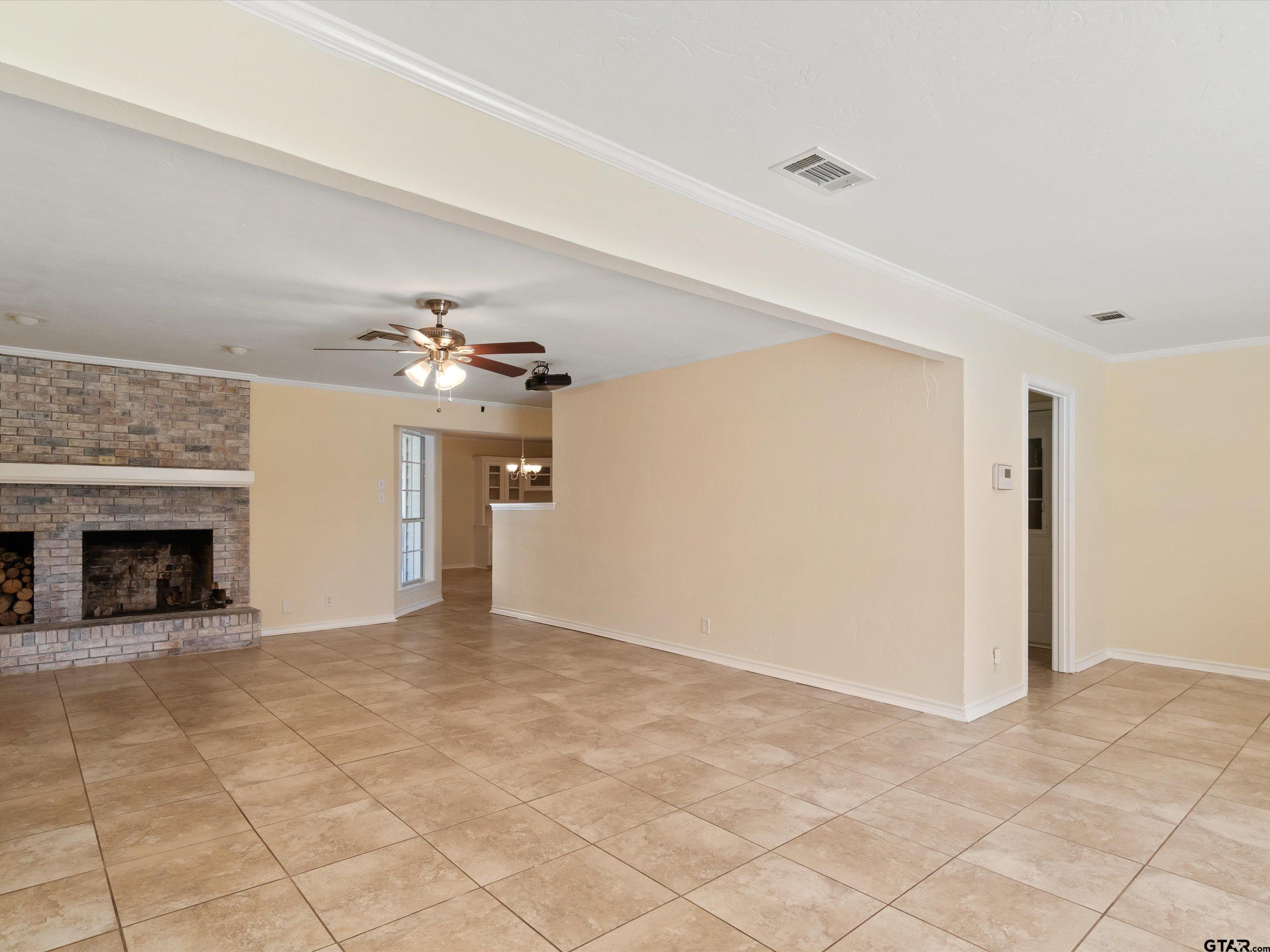442 Golf Road Gilmer, TX 75645 - Photo 13 of 35 a view of an empty room with a fireplace