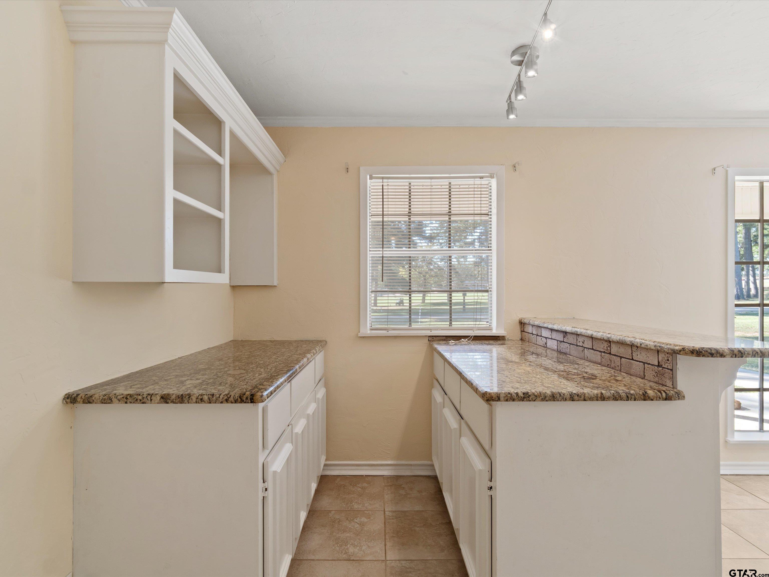 442 Golf Road Gilmer, TX 75645 - Photo 15 of 35 a utility room with granite countertop cabinets washer and dryer