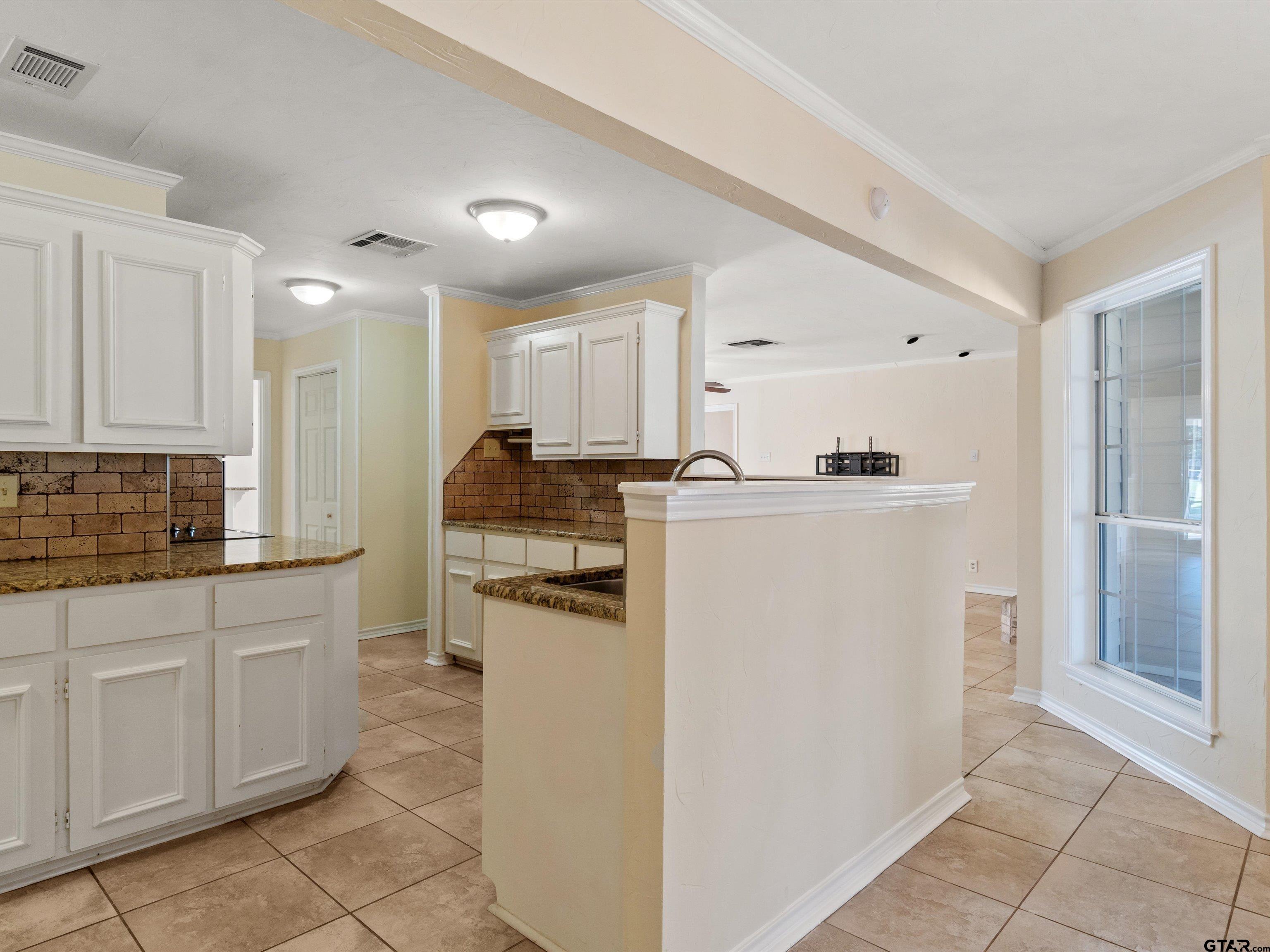 442 Golf Road Gilmer, TX 75645 - Photo 18 of 35 a kitchen with a refrigerator a stove top oven and cabinets