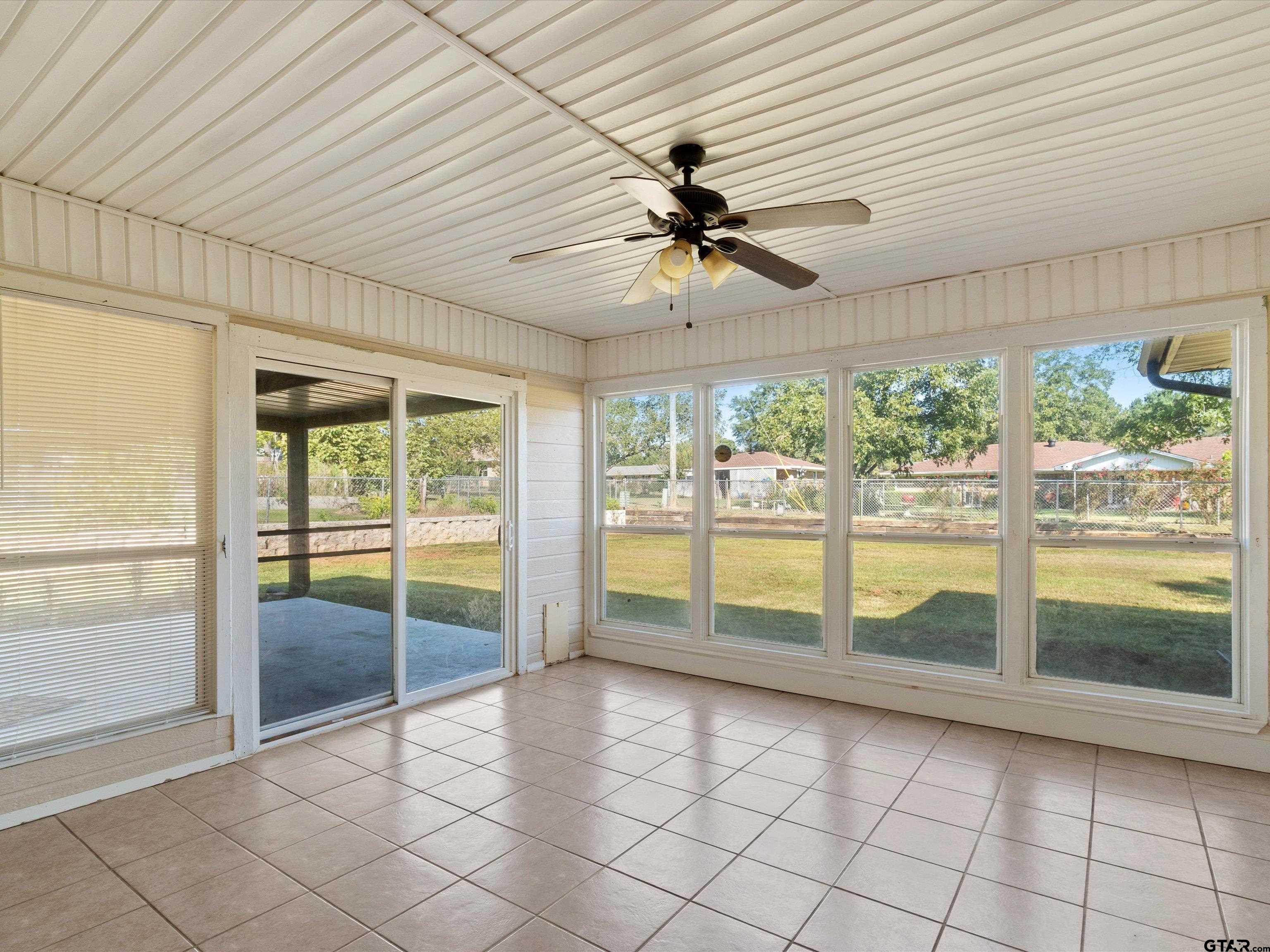 442 Golf Road Gilmer, TX 75645 - Photo 22 of 35 a view of an empty room and window ceiling fan