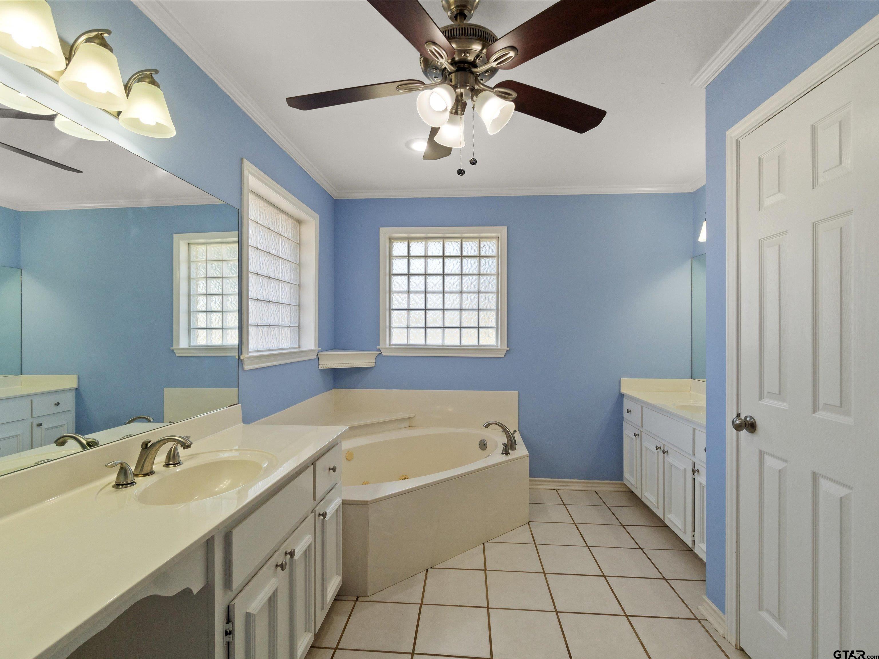 442 Golf Road Gilmer, TX 75645 - Photo 24 of 35 a bathroom with a tub sink and mirror