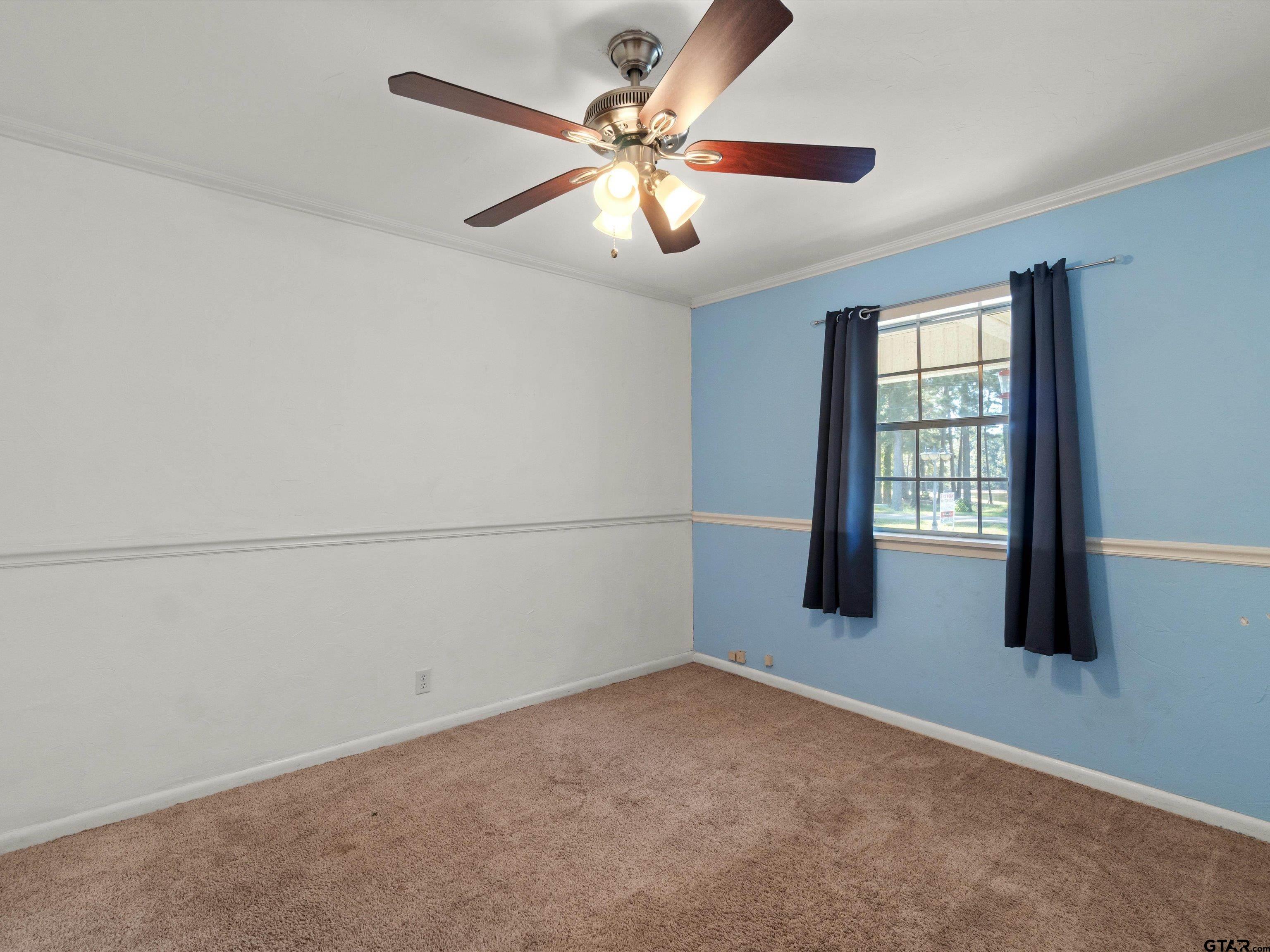 442 Golf Road Gilmer, TX 75645 - Photo 28 of 35 an empty room with chandelier fan