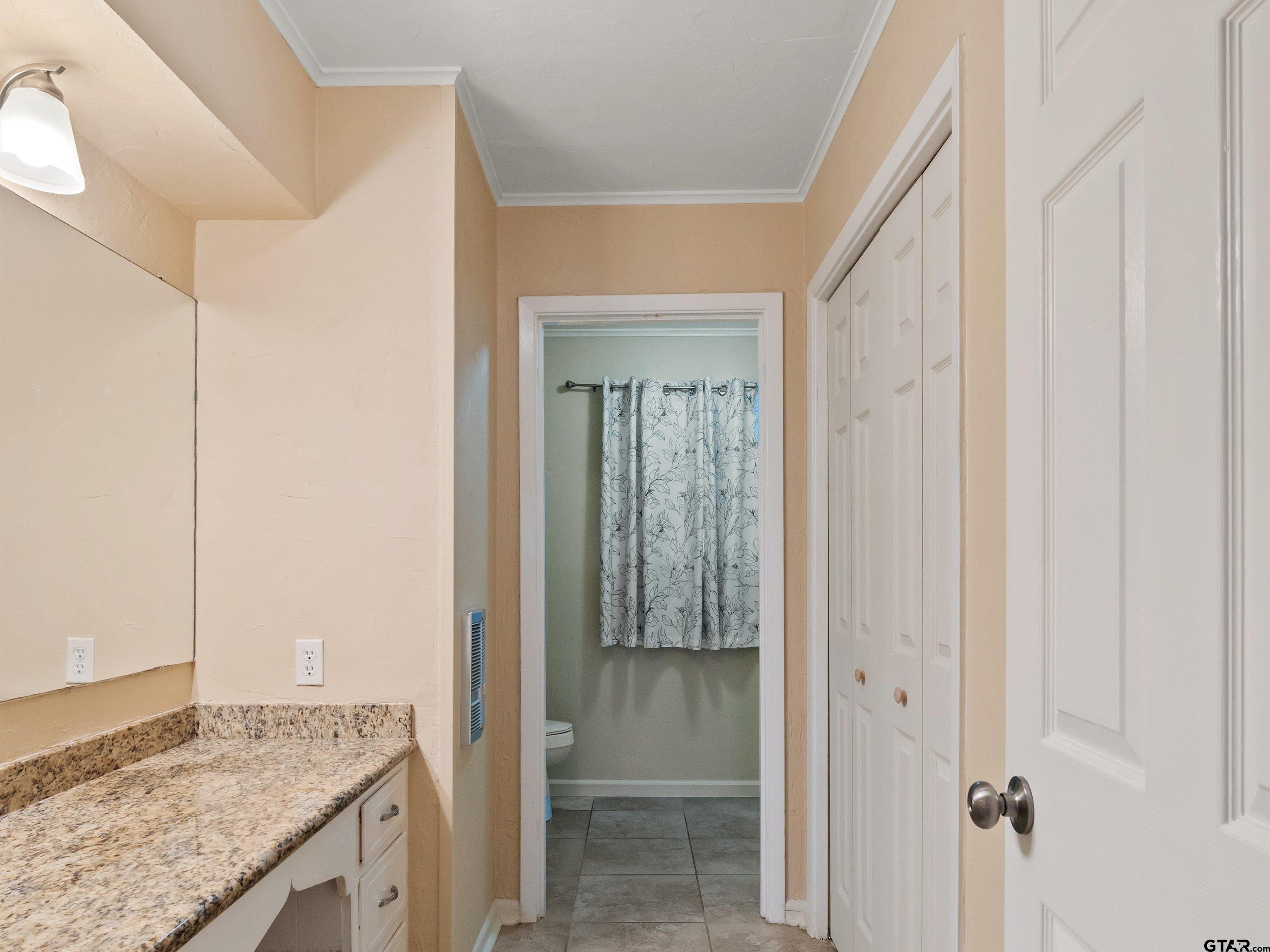 442 Golf Road Gilmer, TX 75645 - Photo 32 of 35 a bathroom with a granite countertop sink and a mirror