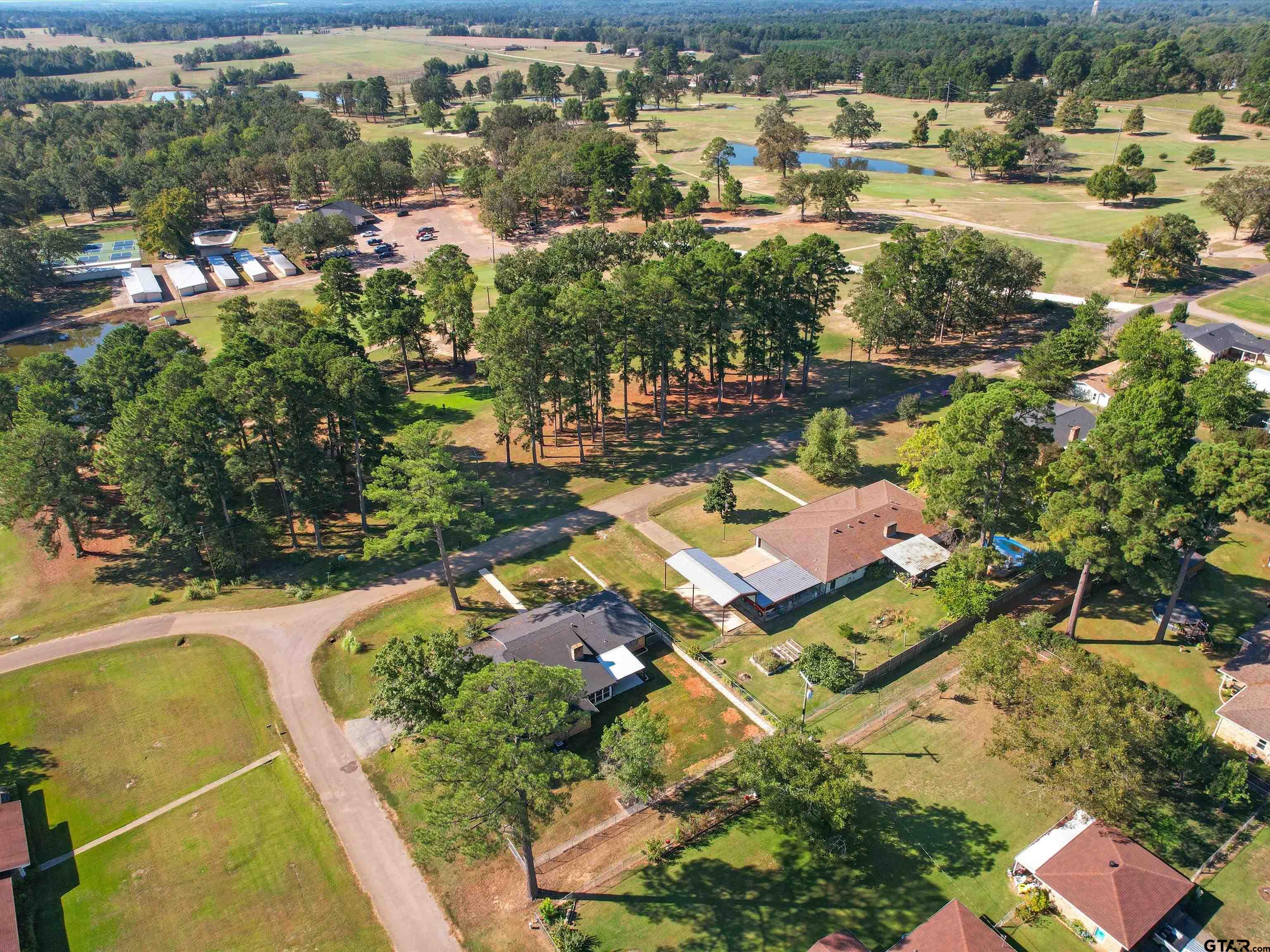 442 Golf Road Gilmer, TX 75645 - Photo 9 of 35 an aerial view of residential houses with outdoor space
