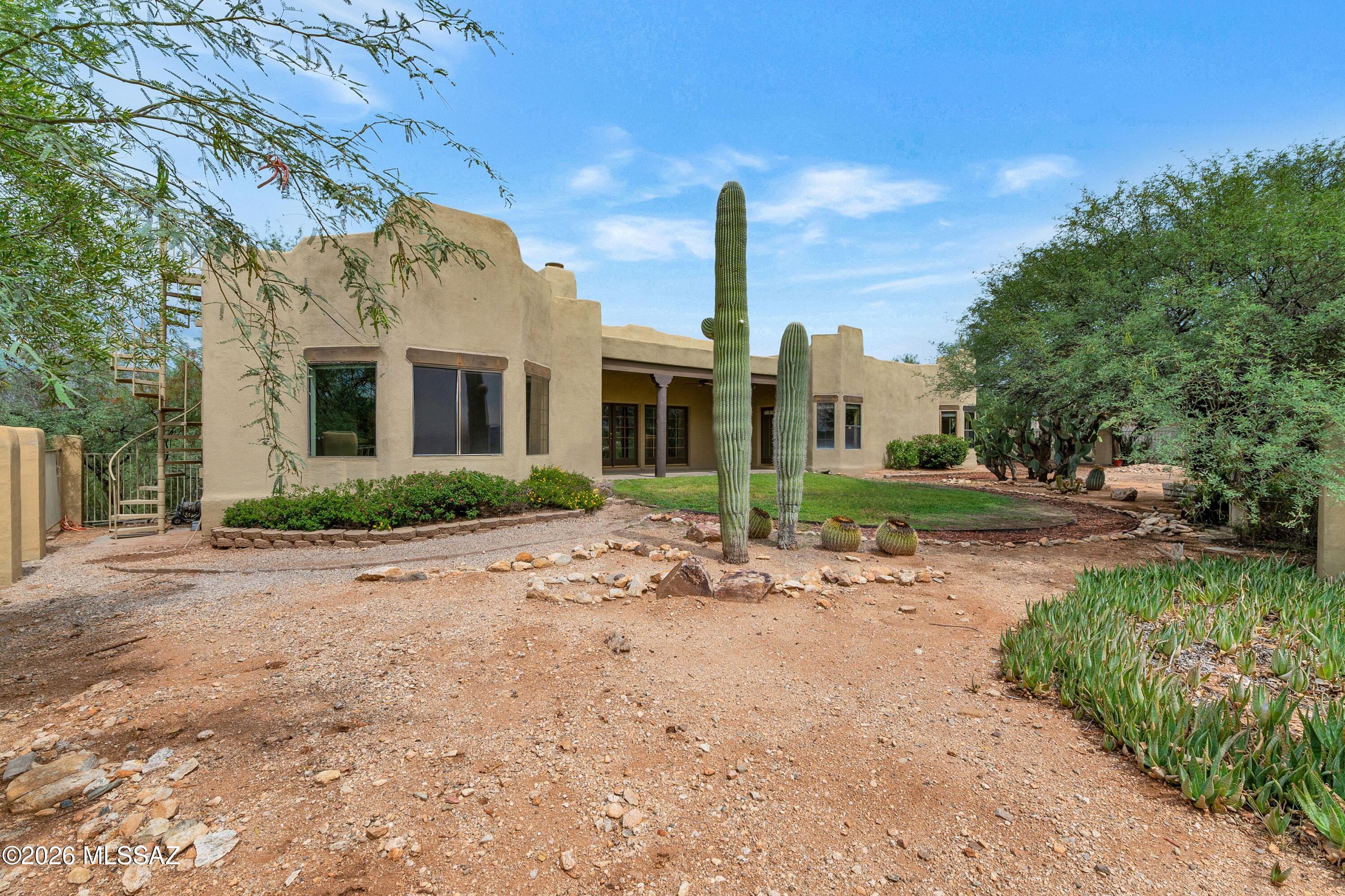 12160 East Tanque Verde Road Tucson, AZ 85749 - Photo 25 of 53 SW style facade with saguaro cacti and desert landscaping.