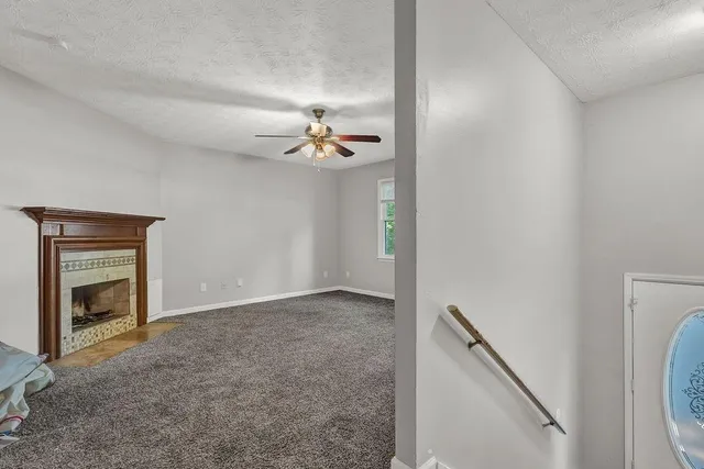 a view of an empty room with a fireplace