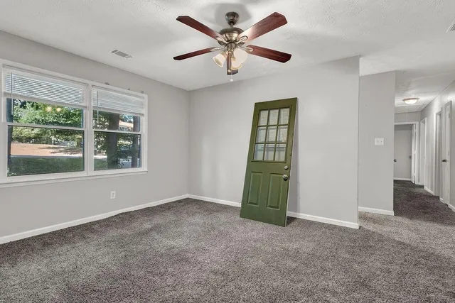 a view of an empty room with a window