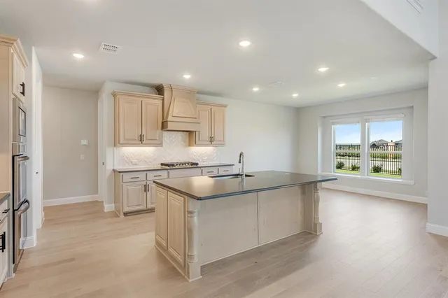 a kitchen with stainless steel appliances granite countertop a sink and a stove
