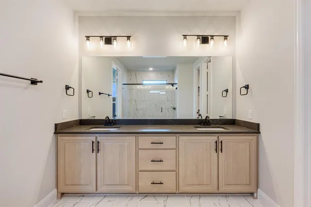 a view of cabinets with granite countertop white cabinets and a sink