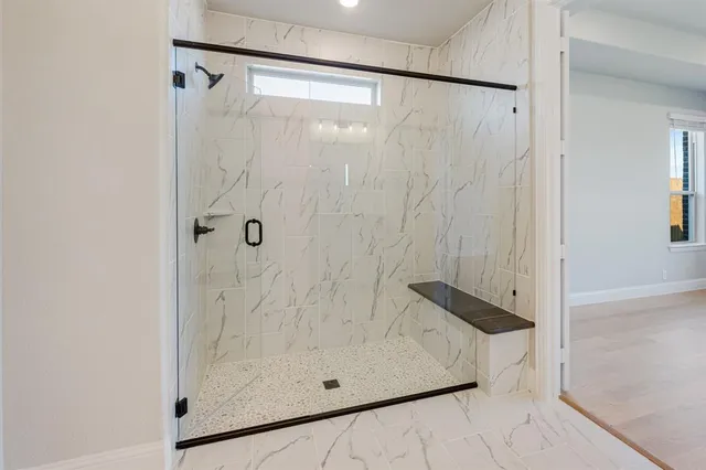a bathroom with a glass shower door