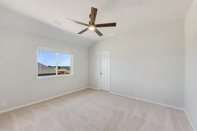 a view of a ceiling fan and a window