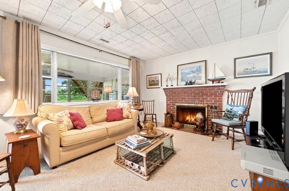 1700 Locust Grove Road Topping, VA 23169 - Photo 22 of 33 Wide window, brick fireplace, ceiling fan, wall-to