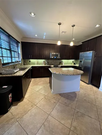 a kitchen with stainless steel appliances granite countertop a sink counter space cabinets and a window