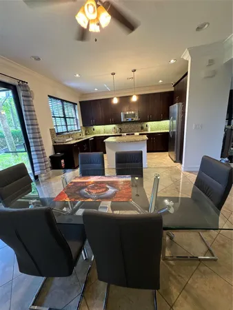 a living room with stainless steel appliances kitchen island granite countertop furniture and a fireplace