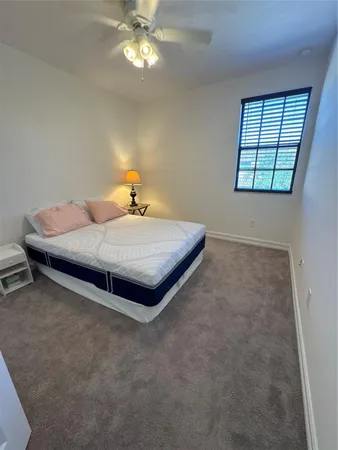 a bed sitting in a room next to a window