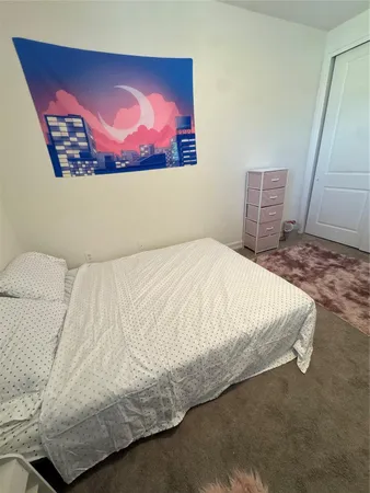 a large bed sitting in a bedroom next to a rug