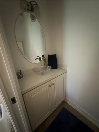a bathroom with a sink and mirror
