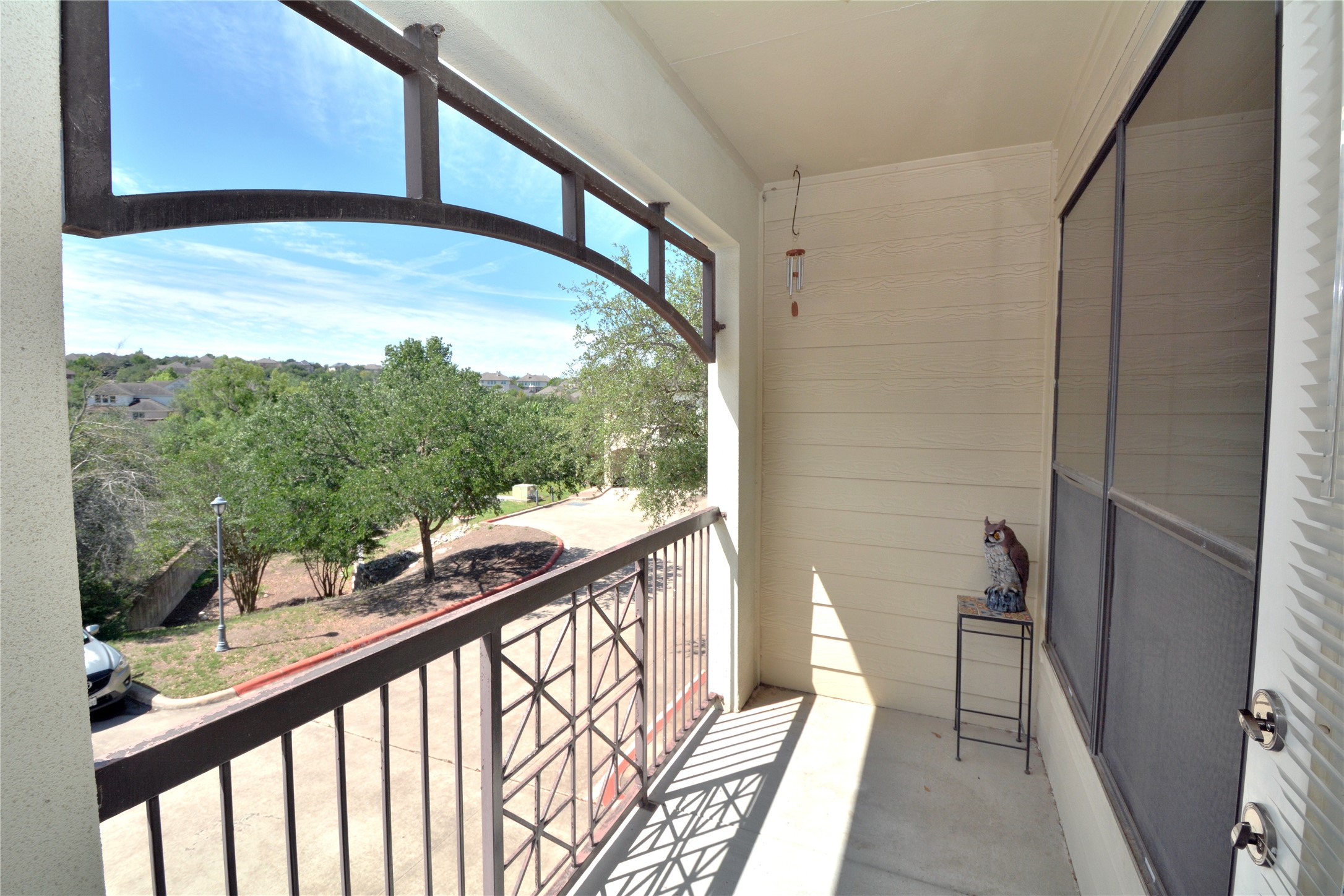 7701 Rialto Boulevard, Unit 124 Austin, TX 78735 - Photo 17 of 23 Covered balcony with a decorative metal railing and an arched architectural element
