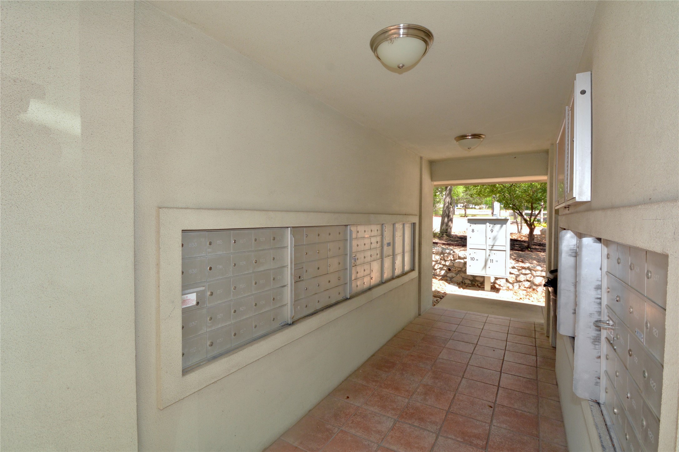 7701 Rialto Boulevard, Unit 124 Austin, TX 78735 - Photo 19 of 23 Covered entryway with tile flooring and multiple wall-mounted mailbox units