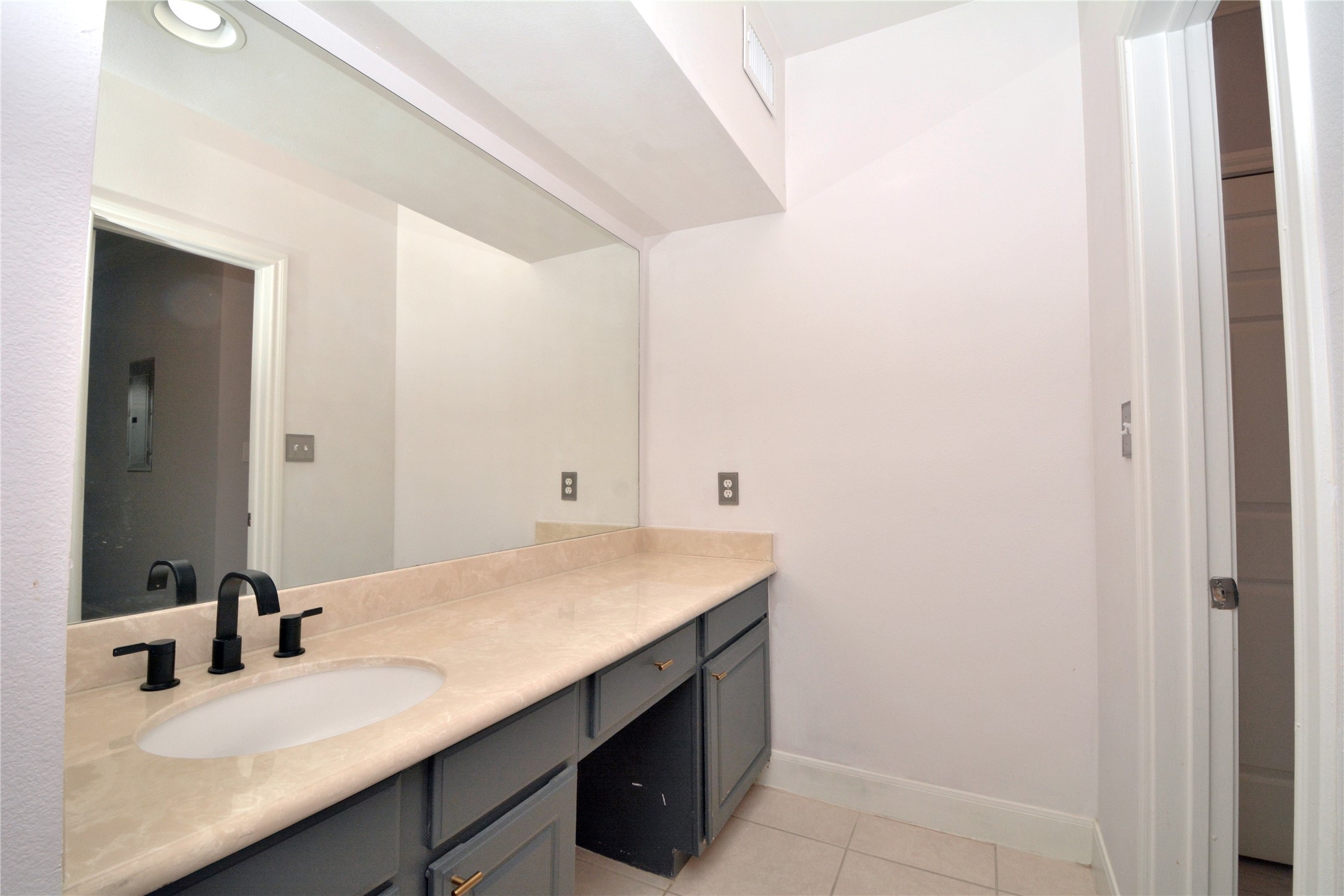 7701 Rialto Boulevard, Unit 124 Austin, TX 78735 - Photo 8 of 23 Bathroom vanity featuring a light-toned countertop, integrated oval sink, and matte black faucet