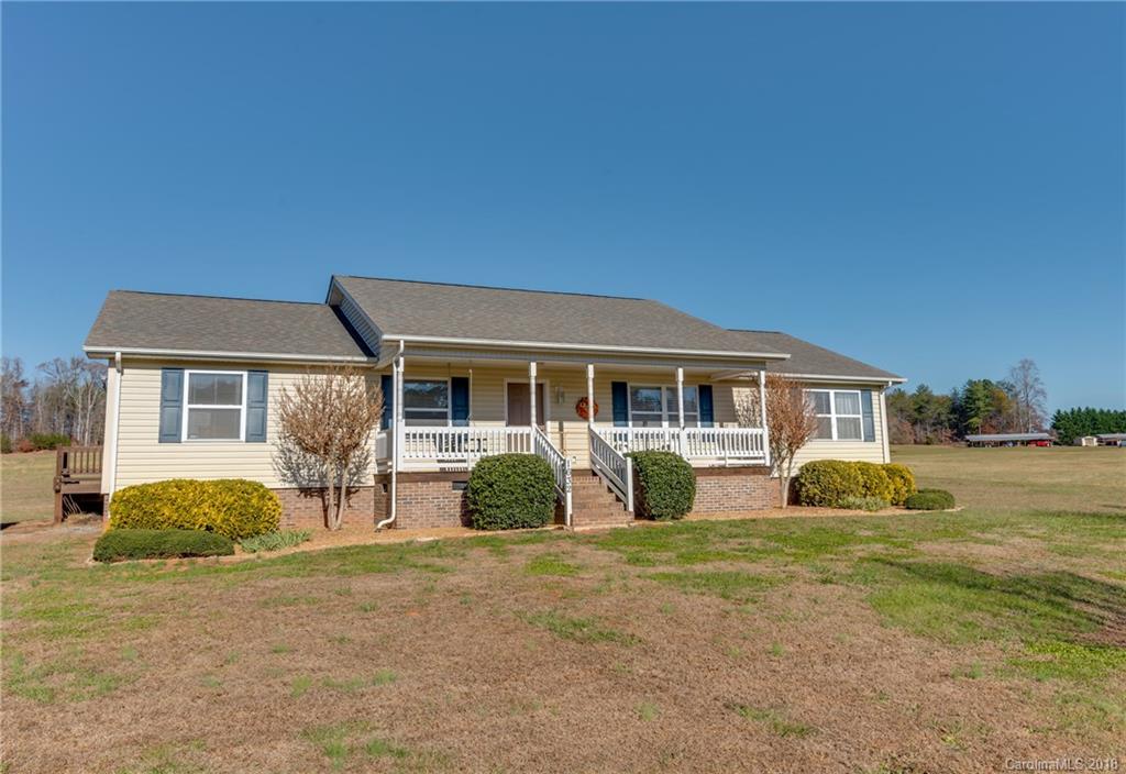 1632 Maple Creek Road Rutherfordton, NC 28139 - Photo 1 of 20 a front view of a house with garden