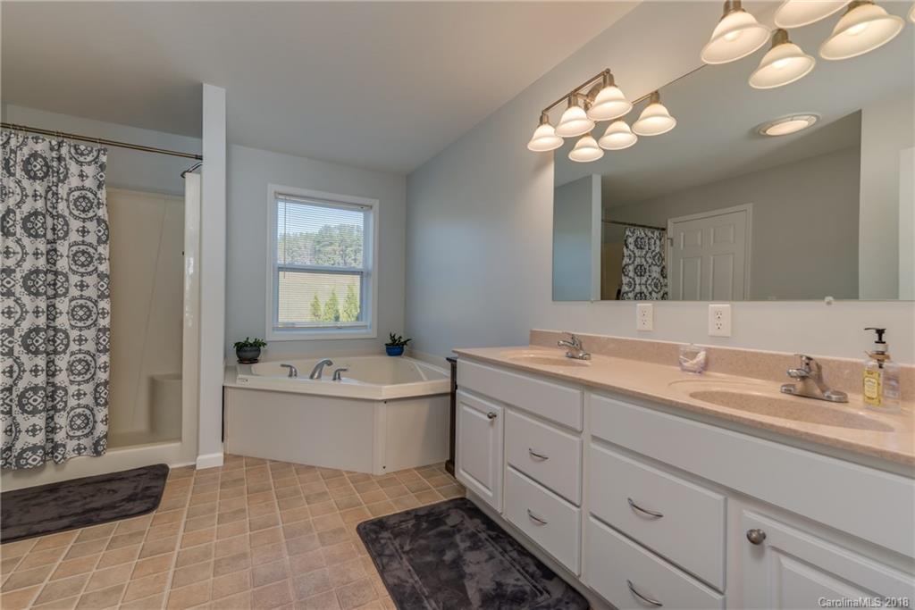 1632 Maple Creek Road Rutherfordton, NC 28139 - Photo 16 of 20 a bathroom with a tub sink and mirror