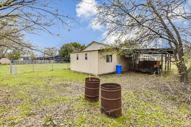 a view of a house with large trees