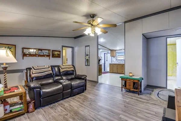 a living room with fireplace furniture and a wooden floor