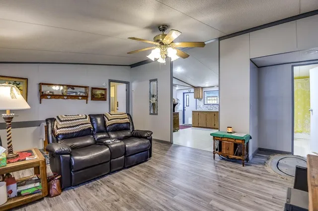 a living room with fireplace furniture and a wooden floor