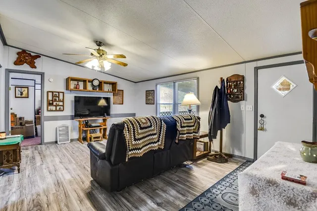 a view of a livingroom with furniture and a flat screen tv