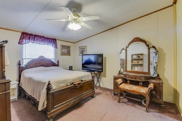 a bedroom with a bed and a chair