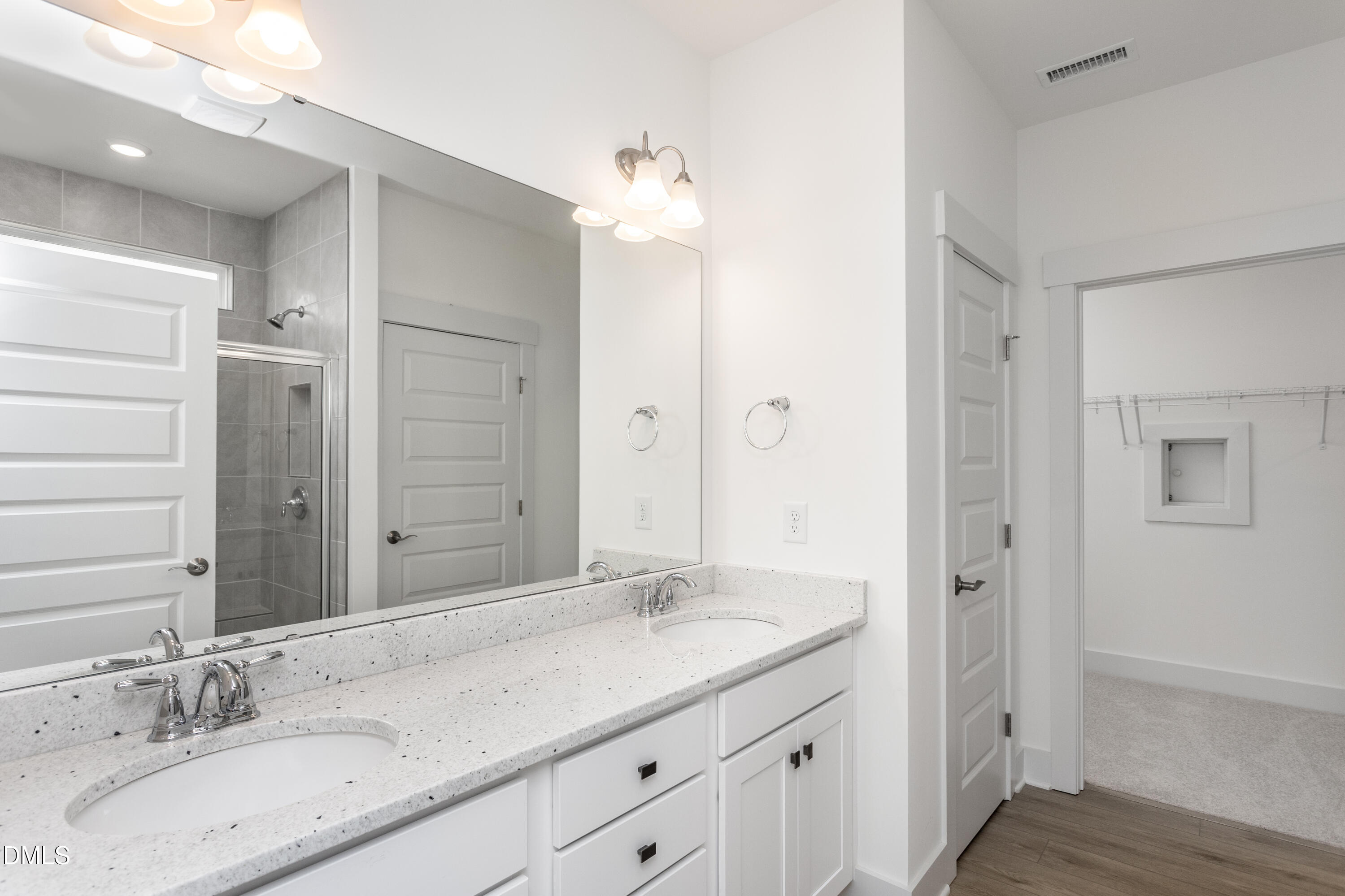 70 Slippery Elm Road Youngsville, NC 27596 - Photo 16 of 32 a bathroom with a granite countertop double vanity sink and a mirror