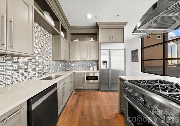 a kitchen with stainless steel appliances granite countertop a stove and a refrigerator