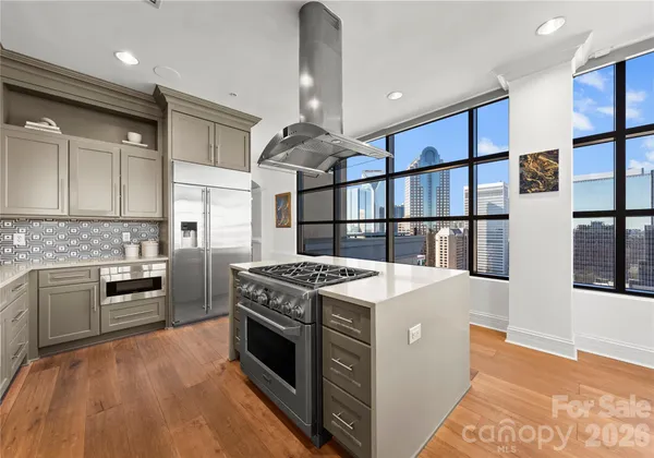 a kitchen with stainless steel appliances granite countertop a stove and a refrigerator