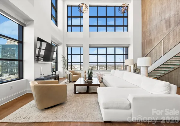 a living room with furniture fireplace and a window