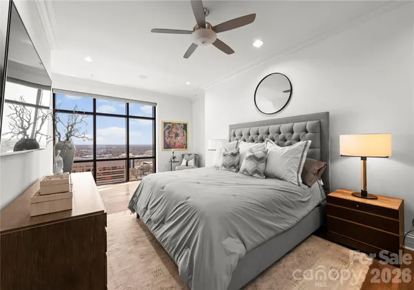 a bedroom with a large bed and a lamp