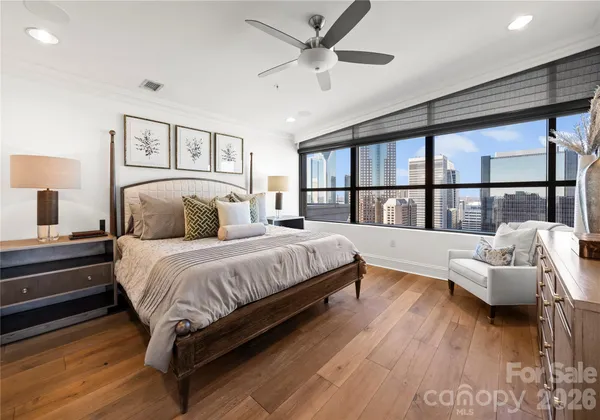 a bedroom with a large bed and a chandelier
