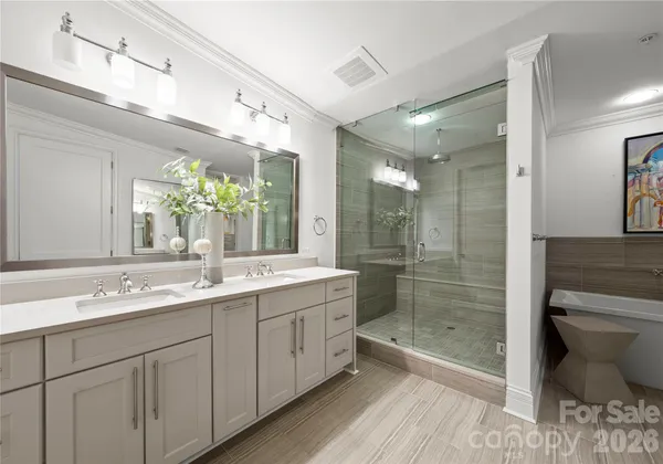 a bathroom with a shower sink mirror and toilet