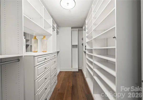 a view of walk in closet with empty racks