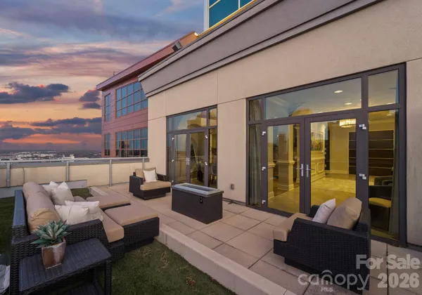 a patio with patio a couch and wooden floor
