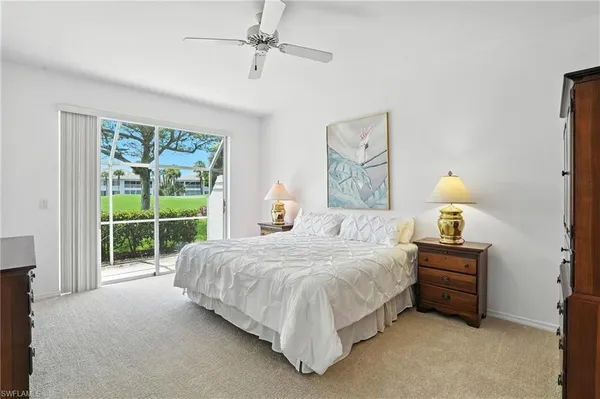 a bedroom with a bed couch and window