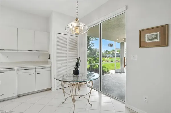 a view of a dining room kitchen with a chandelier