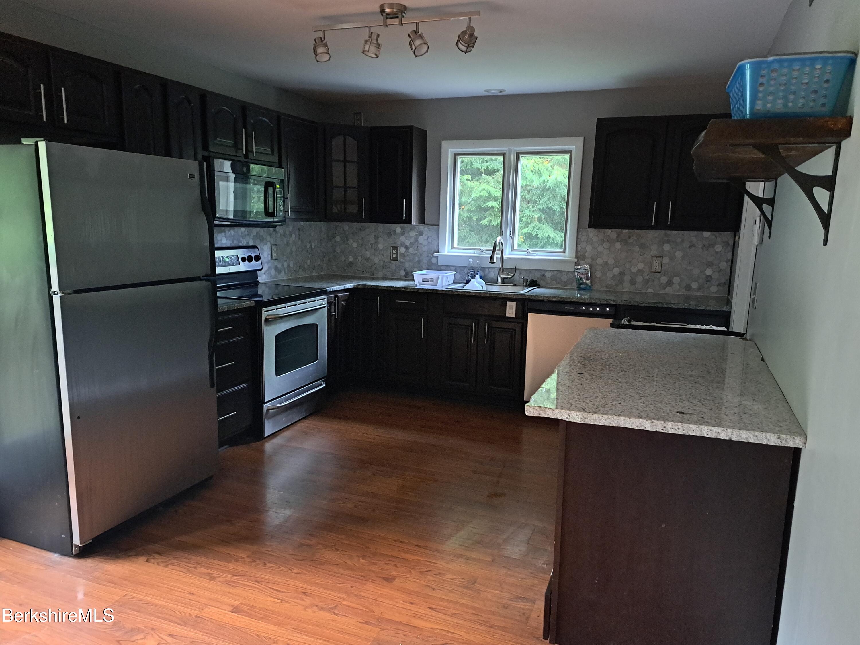 290 Lenox Avenue, Unit 1 Pittsfield, MA 01201 - Photo 3 of 8 a kitchen with a sink stove and refrigerator