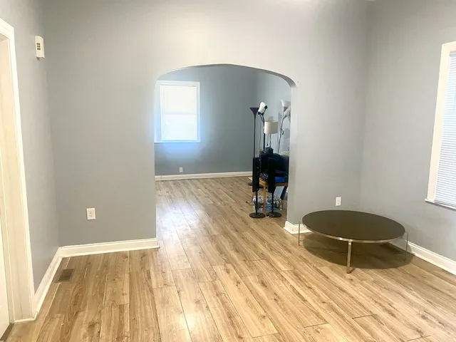 a room with wooden floor and gym equipment