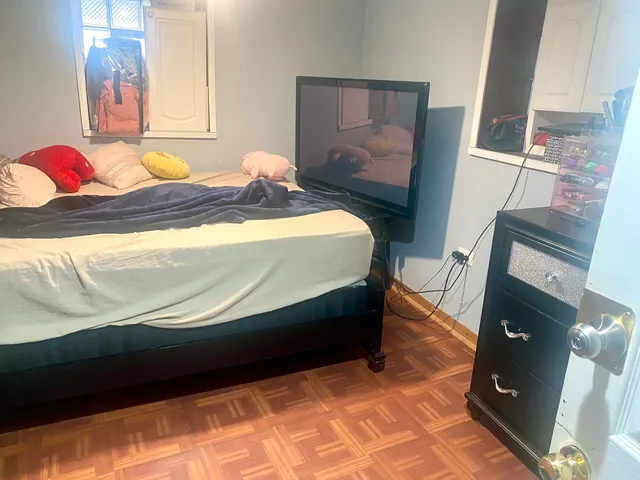 a bedroom with a bed and dresser