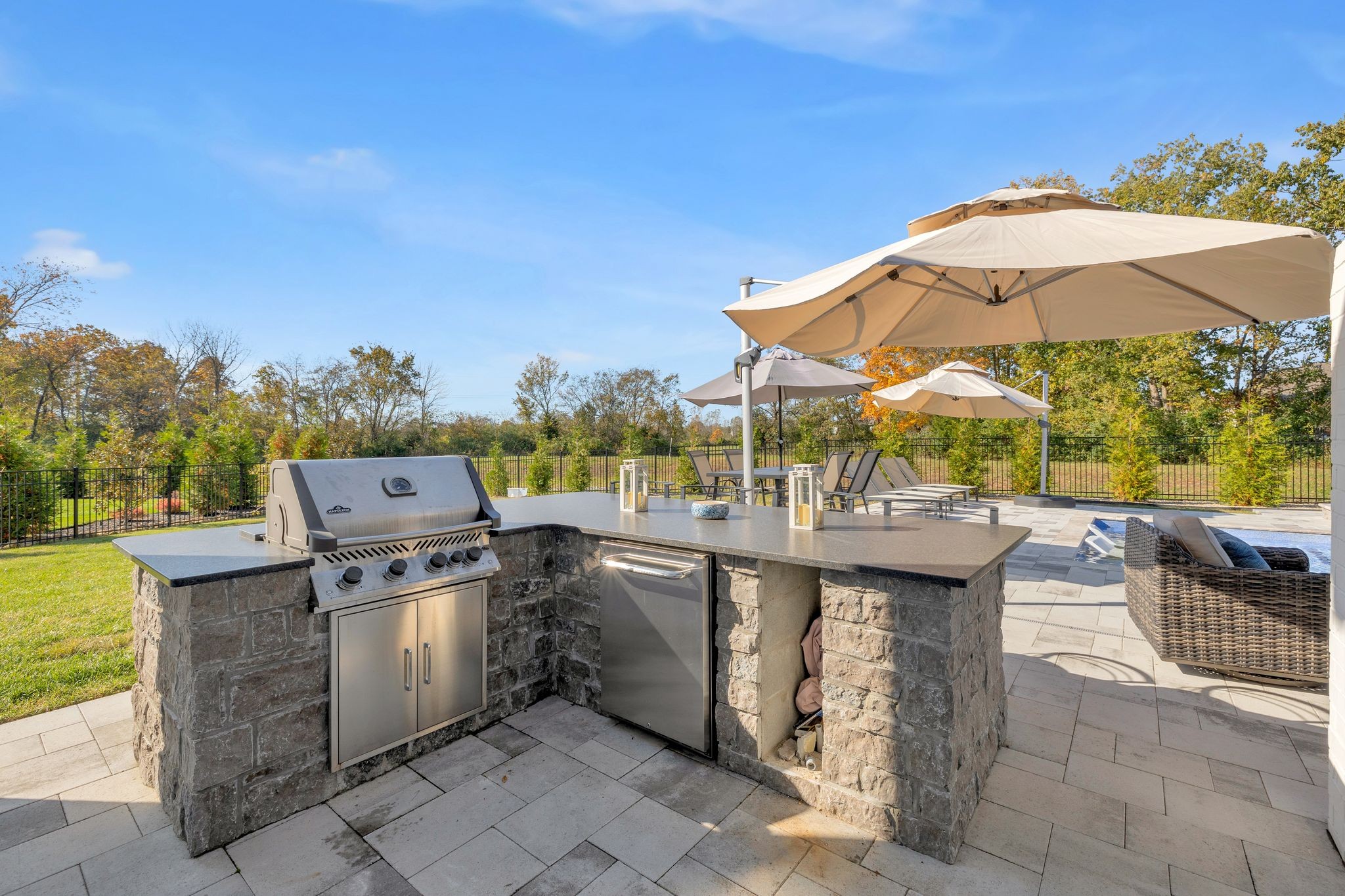 1032 Abbey Rd Way Spring Hill, TN 37174 - Photo 47 of 51 a view of a patio with table and chairs under an umbrella
